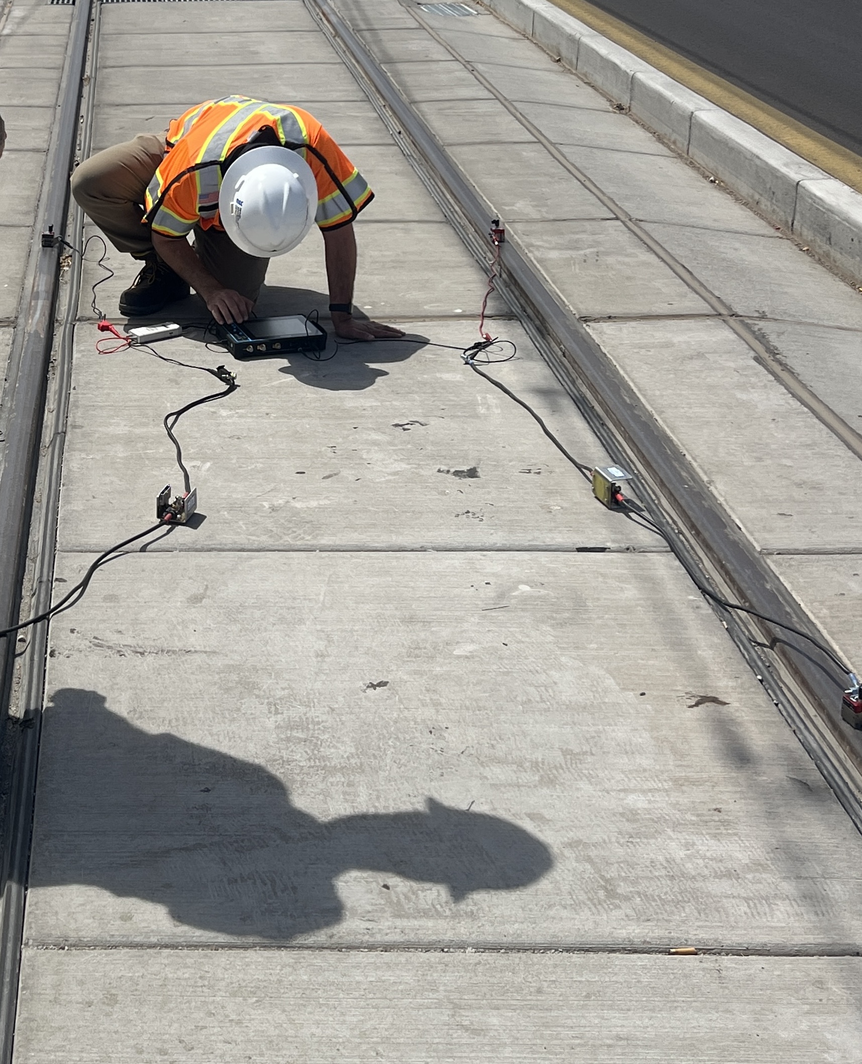 Signal maintainer testing a track circuit with meters.